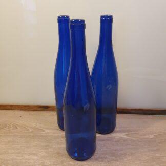 3 blå flasker i glas